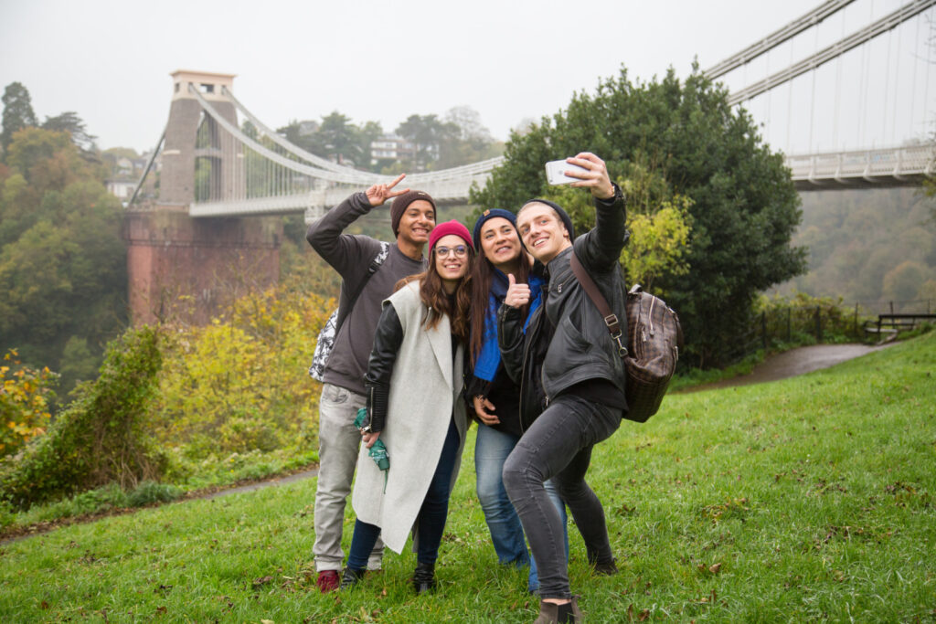 EC Bristol students taking a selfie near Clifton Suspension Bridge on an overcast day