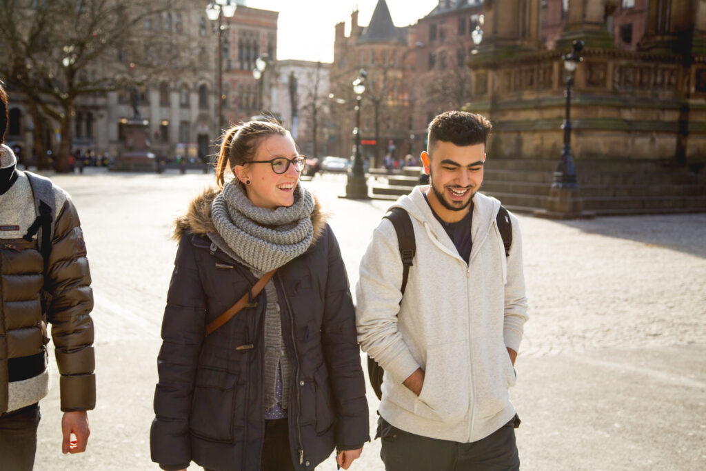 Three EC Manchester students walking through the city
