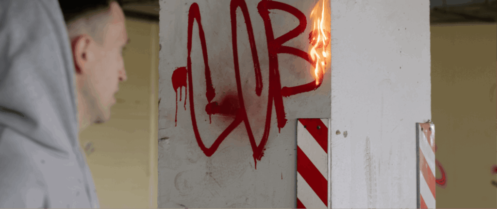 Vandalised wall with graffiti and property damage