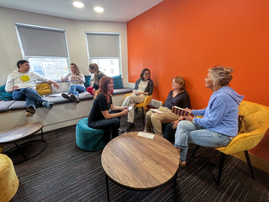Adult students socialising and relaxing in the student lounge at EC Brighton 30+.